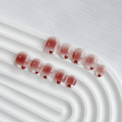 Uñas postizas degradadas con temática de corazones