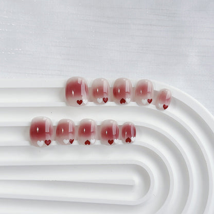 Uñas postizas degradadas con temática de corazones