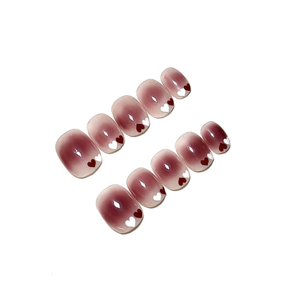 Uñas postizas degradadas con temática de corazones